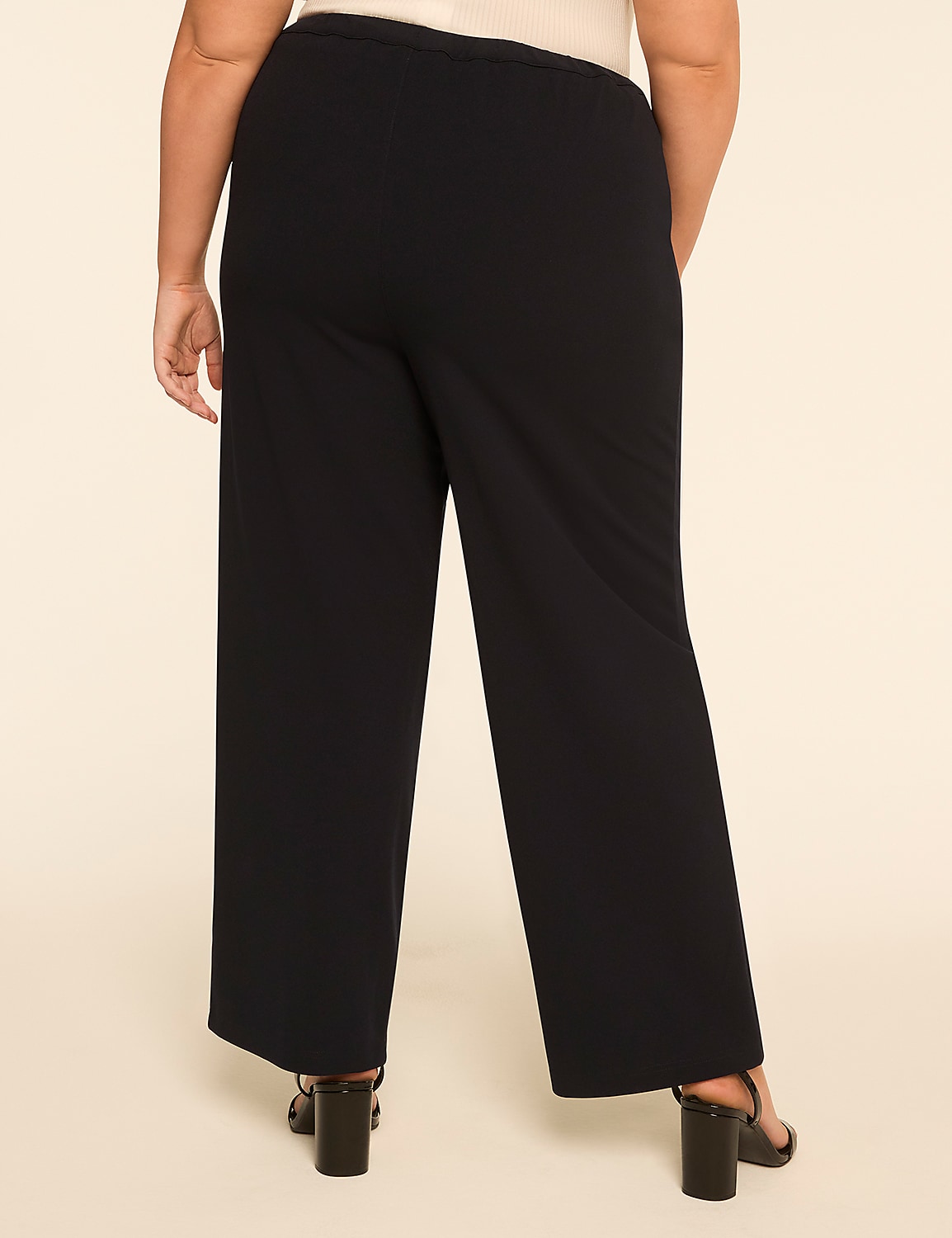 A person wearing black wide-leg pants and black heels stands against a plain beige background. Product Image 2