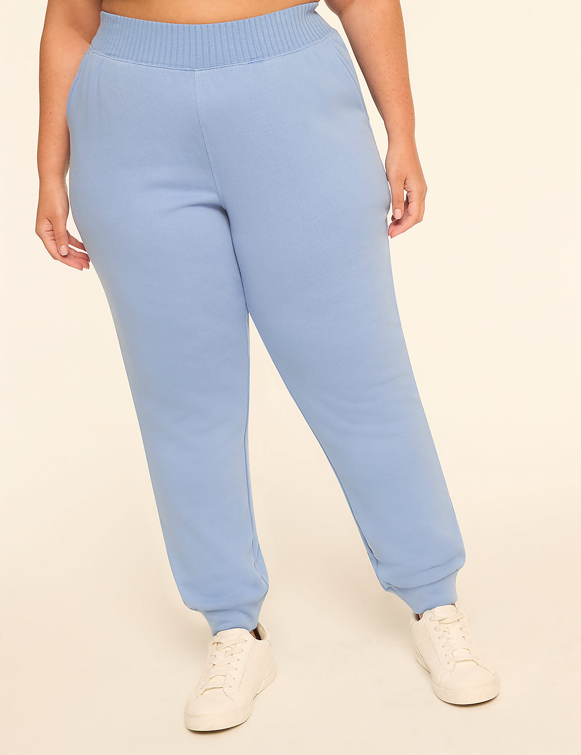 A person wearing light blue sweatpants and white sneakers stands against a plain, light-colored background. Product Image 1