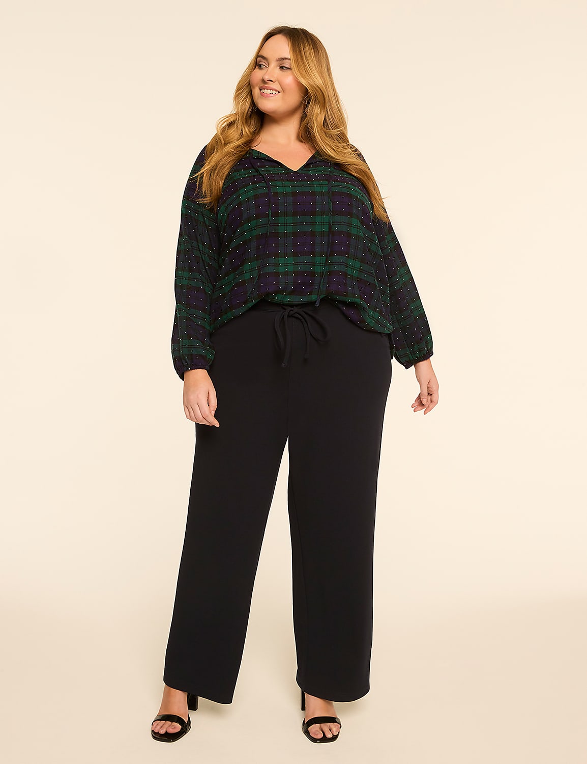 A woman in a plaid top and black pants stands against a plain, light-colored background. Product Image 3