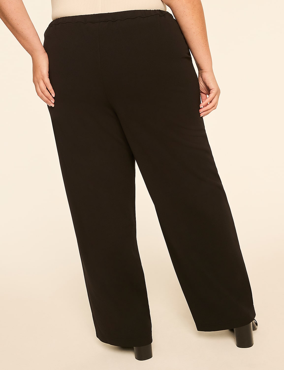 A person wearing black wide-leg pants stands against a plain, light-colored background. Product Image 2