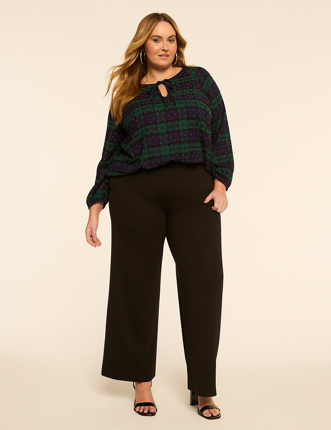 A plus-size woman in a plaid top and black pants stands against a plain, light-colored background. Product Image 3