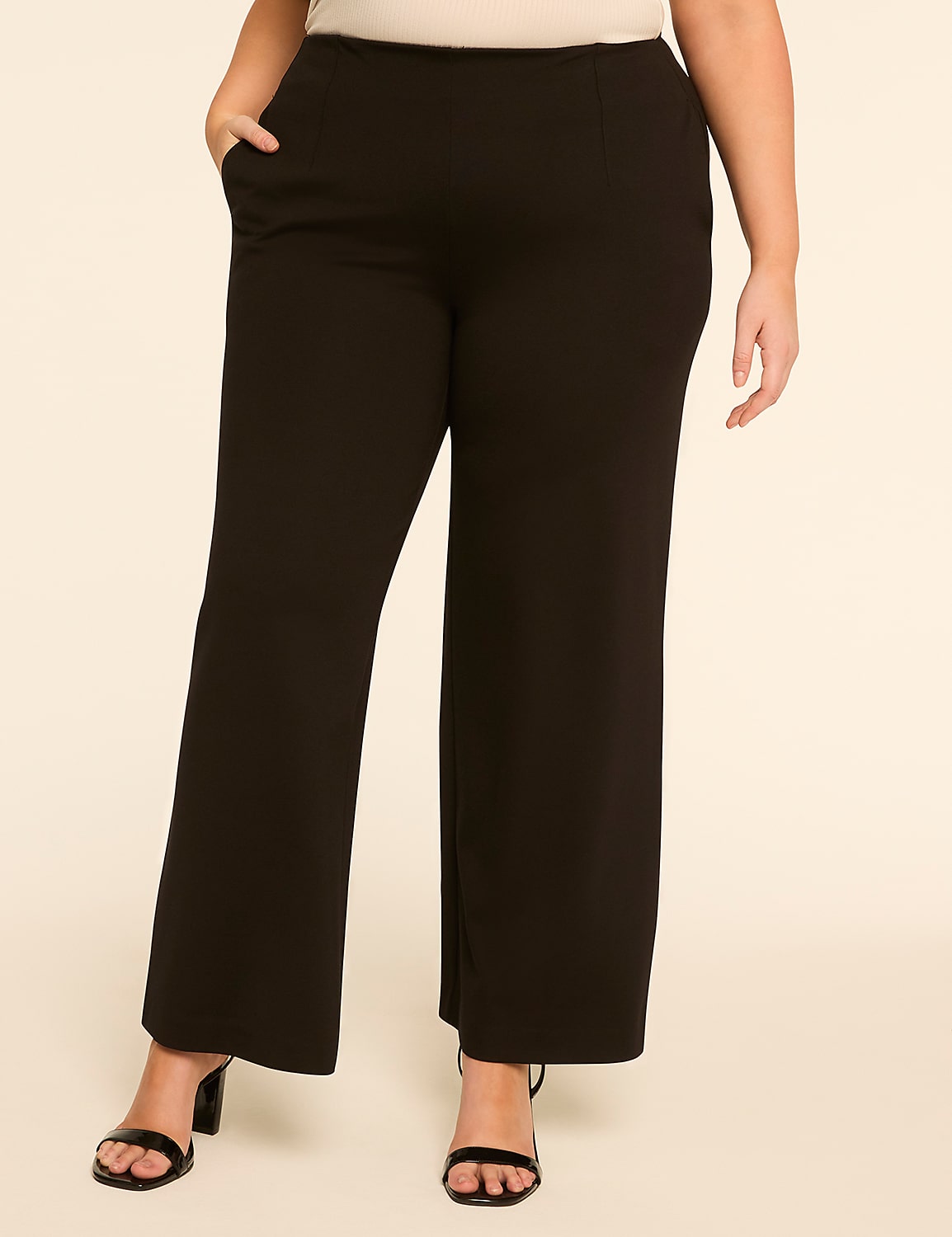 A person wearing black wide-leg pants and black heels stands against a plain, light-colored background. Product Image 1