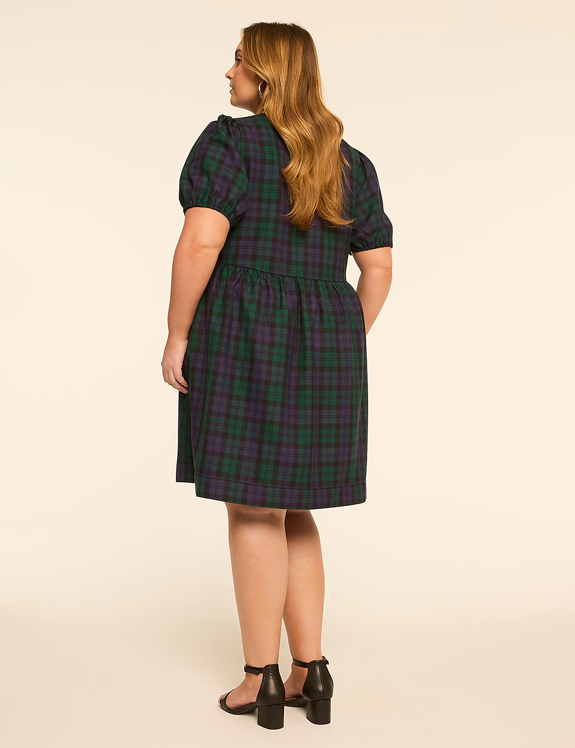A woman in a green and purple plaid dress stands against a plain, light-colored background. Product Image 2