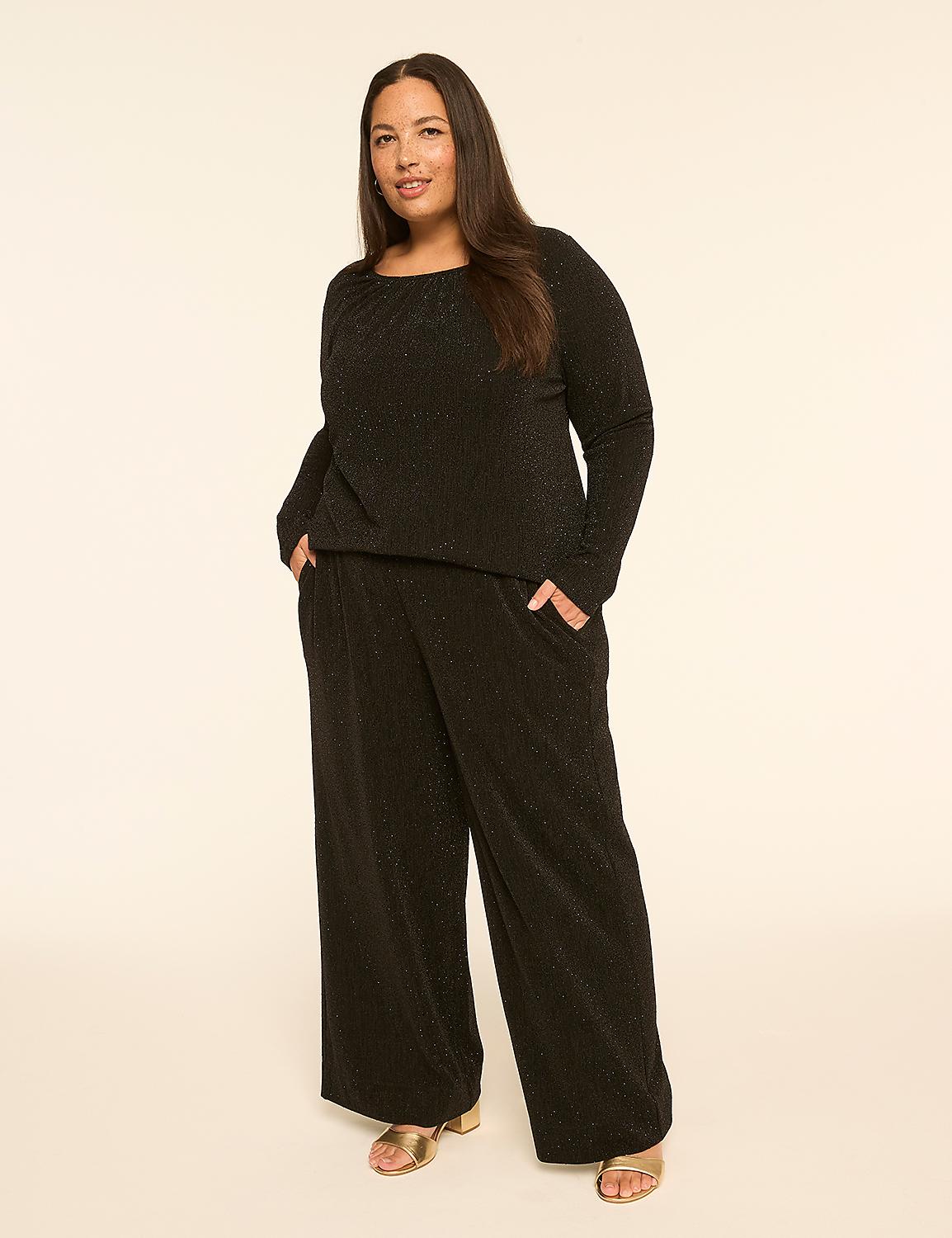A woman in a black textured top and wide-leg pants stands against a plain, light-colored background. Product Image 3