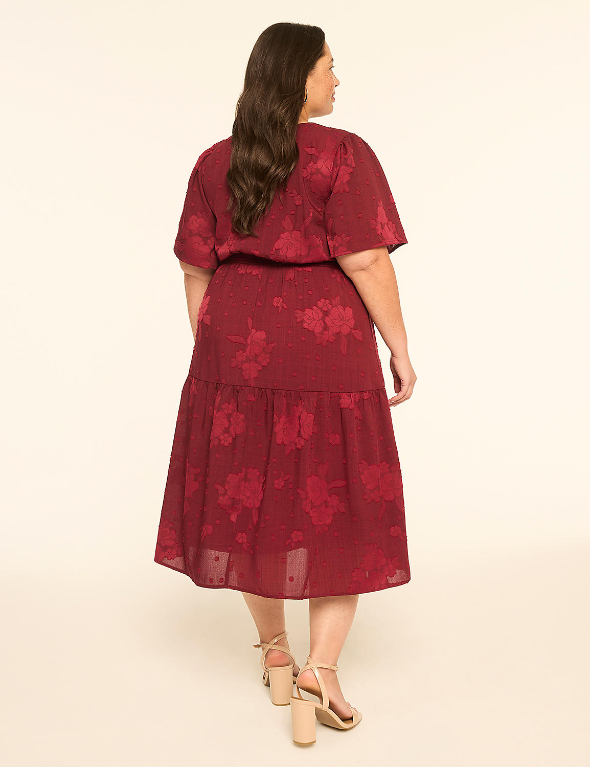 A woman in a burgundy floral dress stands against a plain cream background. Product Image 2