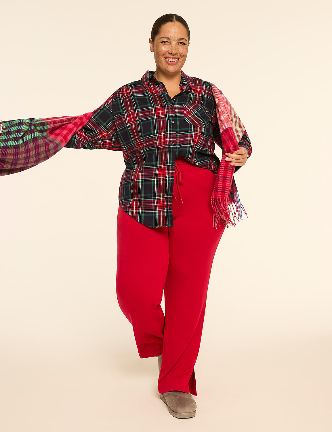 A smiling woman in a plaid shirt and red pants poses with a colorful scarf against a plain, light background. Product Image 4