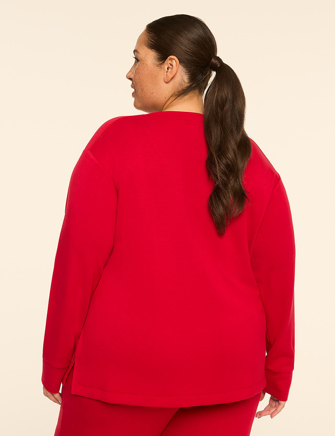 A woman in a red sweater and pants stands against a plain, light-colored background. Product Image 2