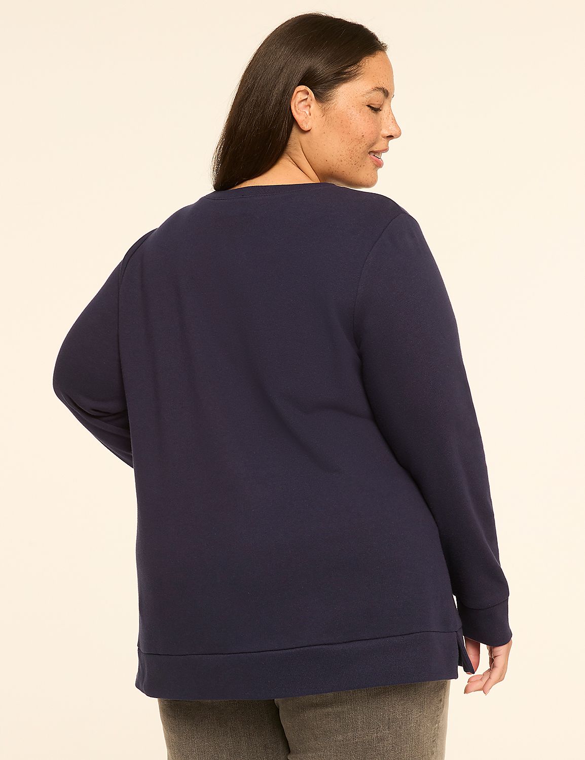 A woman in a navy sweatshirt stands against a plain, light-colored background. Product Image 2