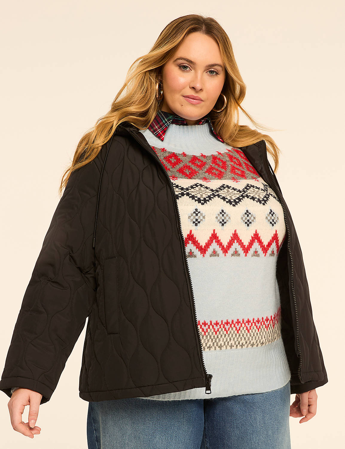 A woman in a quilted black jacket and a colorful fair isle sweater stands against a plain, light-colored background. Product Image 1