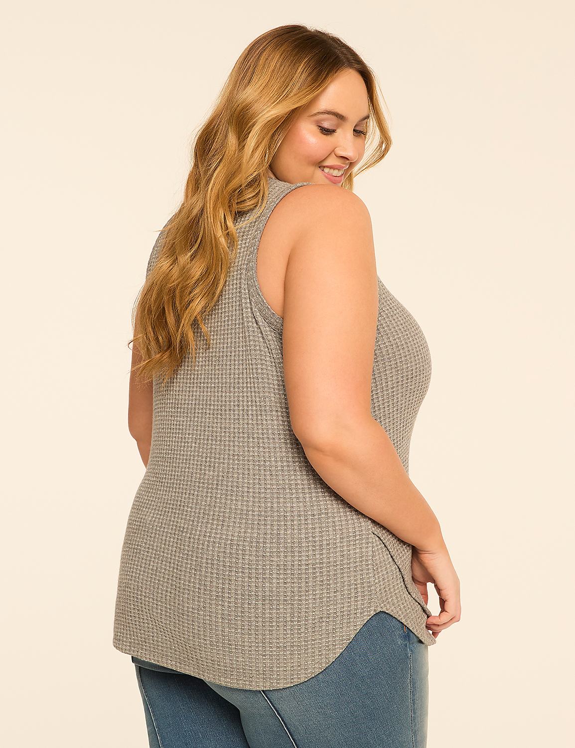 A woman in a gray waffle-knit tank top and blue jeans smiles over her shoulder against a plain, light-colored background. Product Image 2