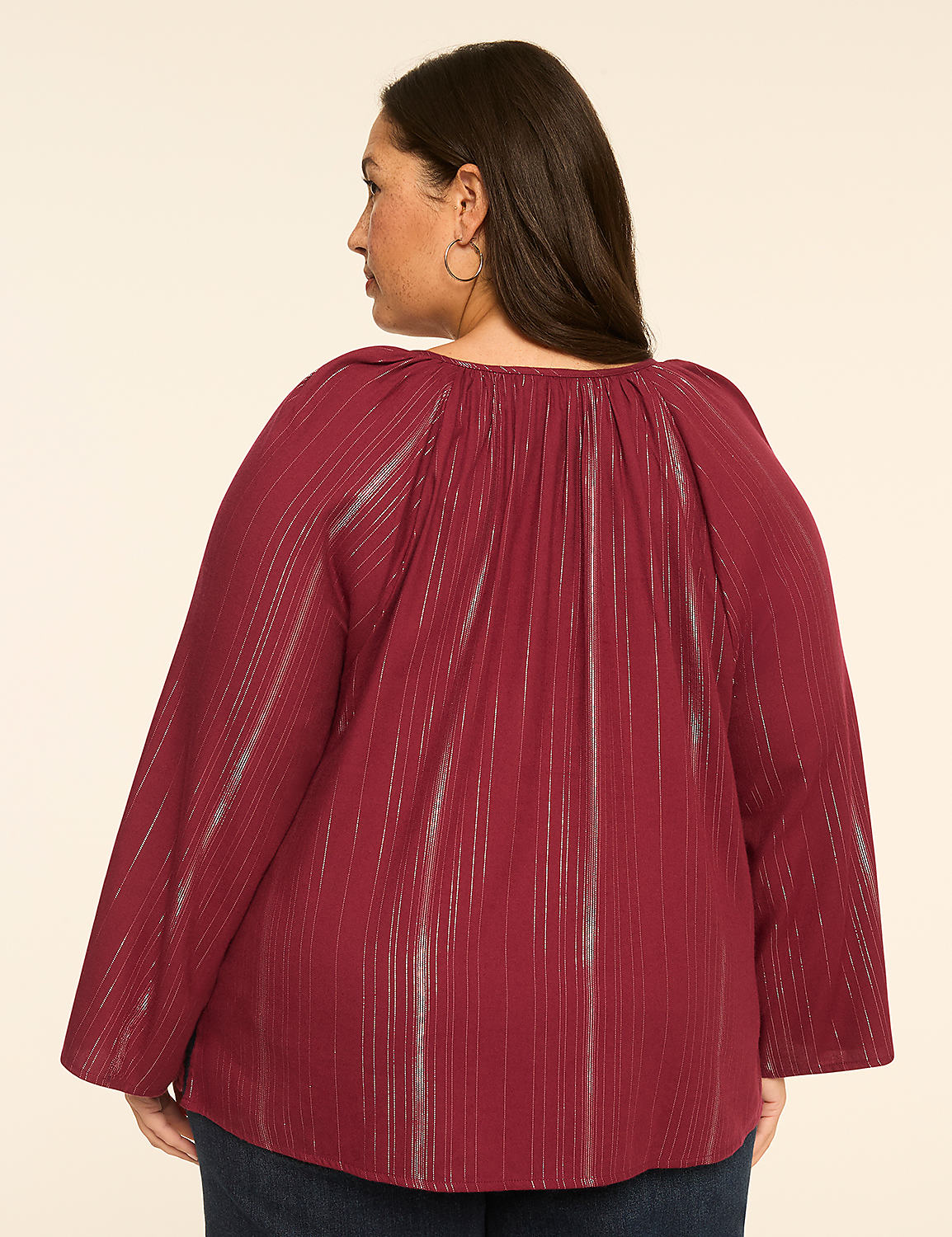 A woman in a maroon striped blouse stands against a plain beige background. Product Image 2