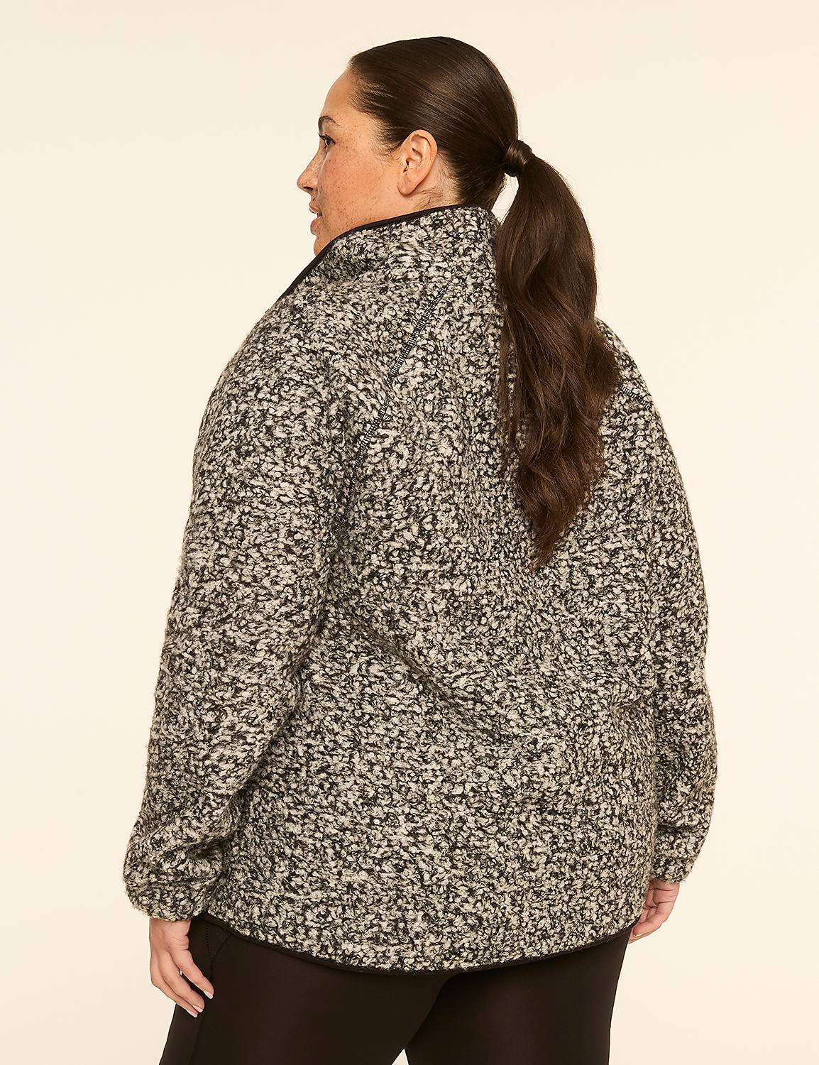 A woman in a speckled gray jacket stands against a plain, light-colored background. Product Image 2