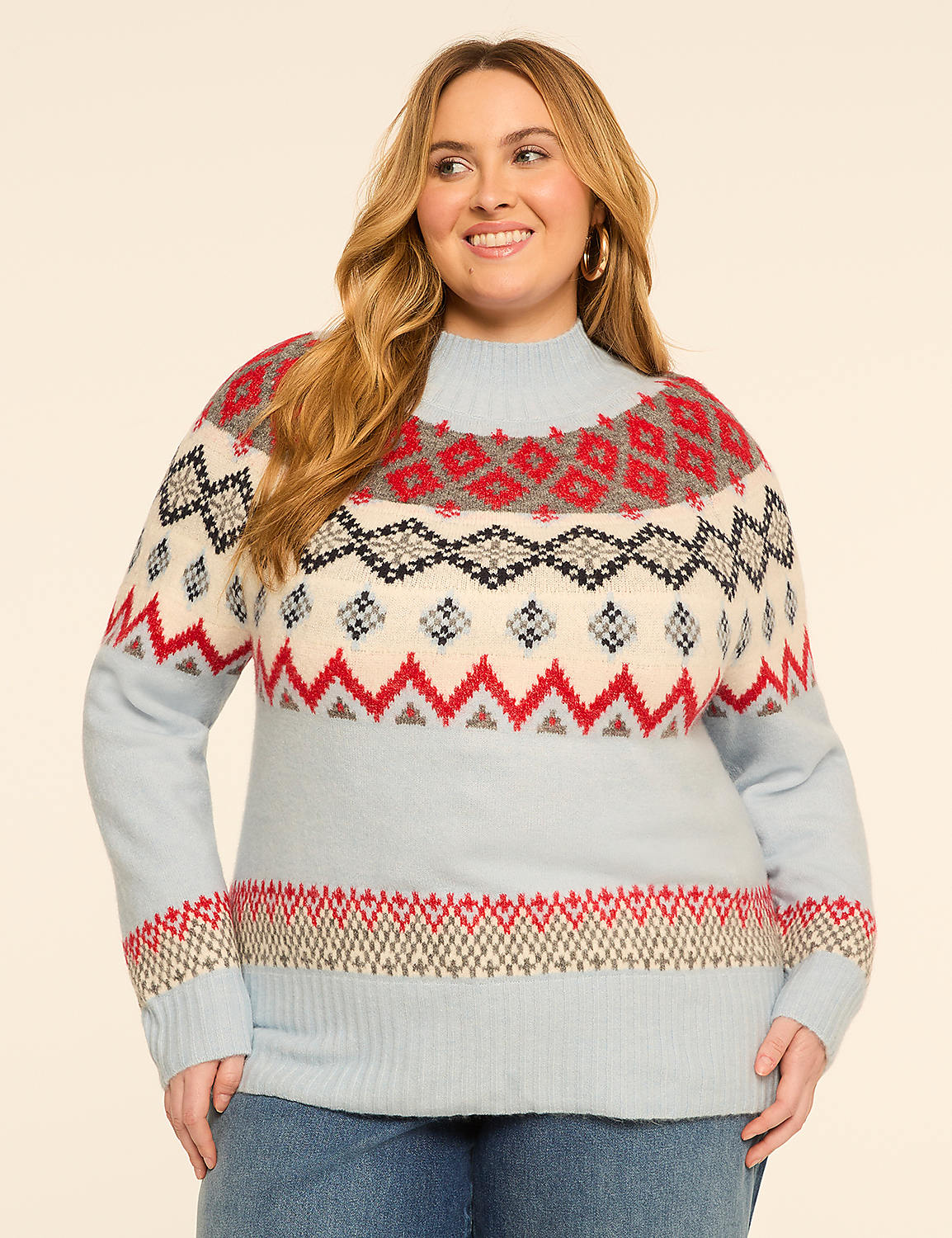 A woman in a light blue Fair Isle sweater smiles against a plain, light-colored background. Product Image 1