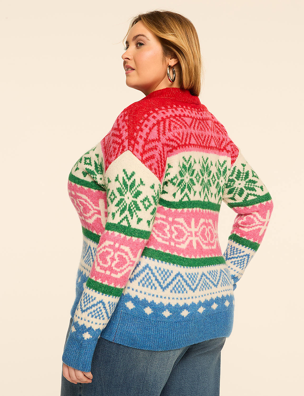 A woman in a colorful, patterned sweater stands against a plain, light-colored background. Product Image 2