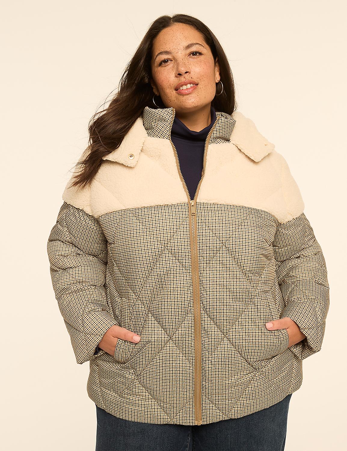 A woman in a cream and plaid puffer jacket stands against a plain, light-colored background. Product Image 1