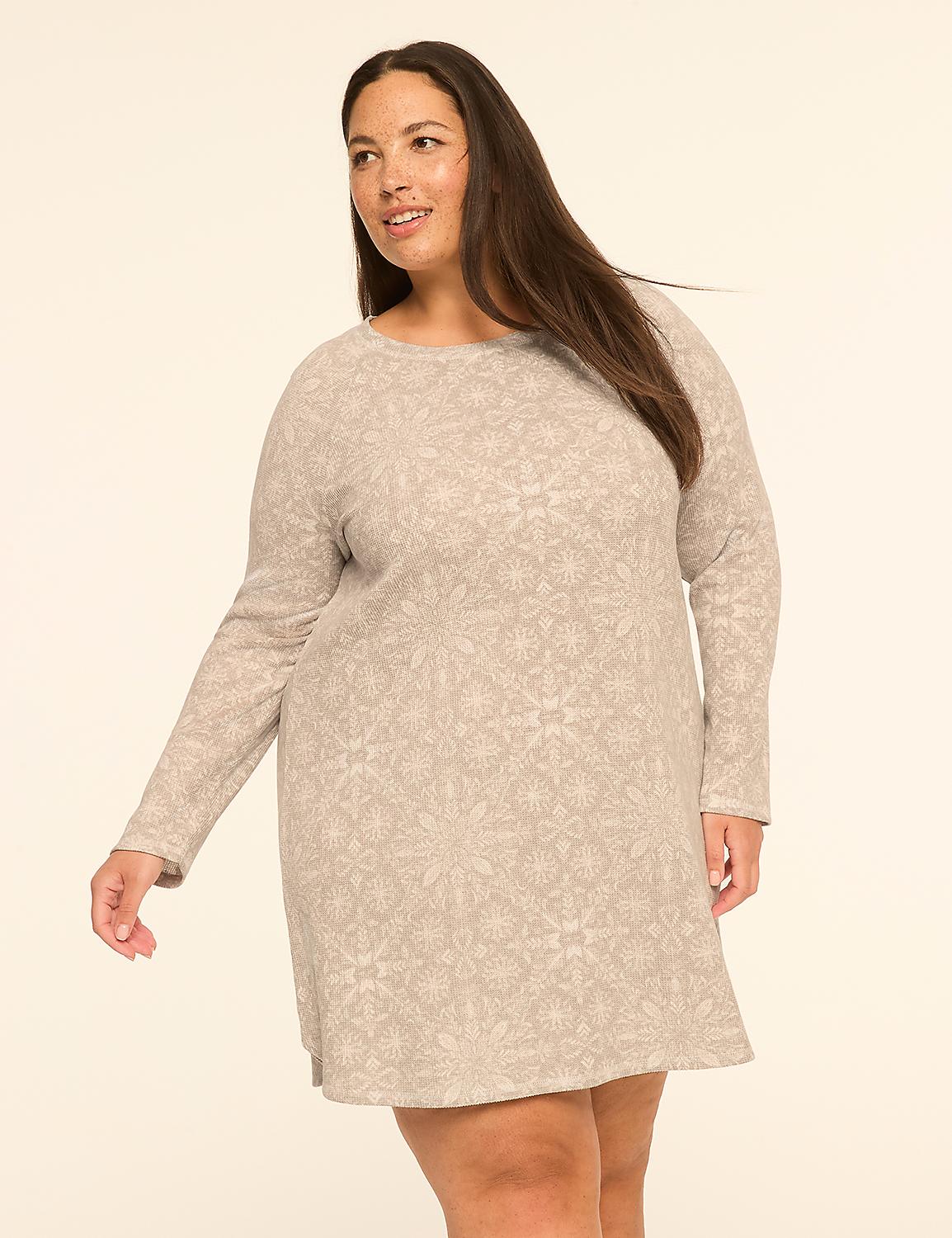 A woman in a patterned dress stands against a plain, light-colored background. Product Image 1