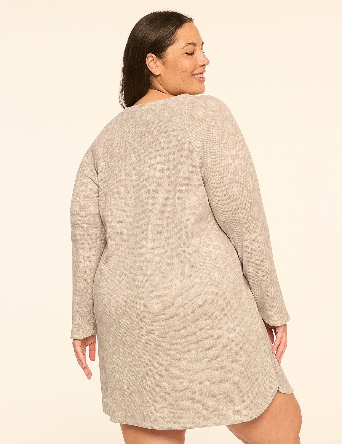 A woman in a patterned dress stands against a plain, light-colored background. Product Image 2