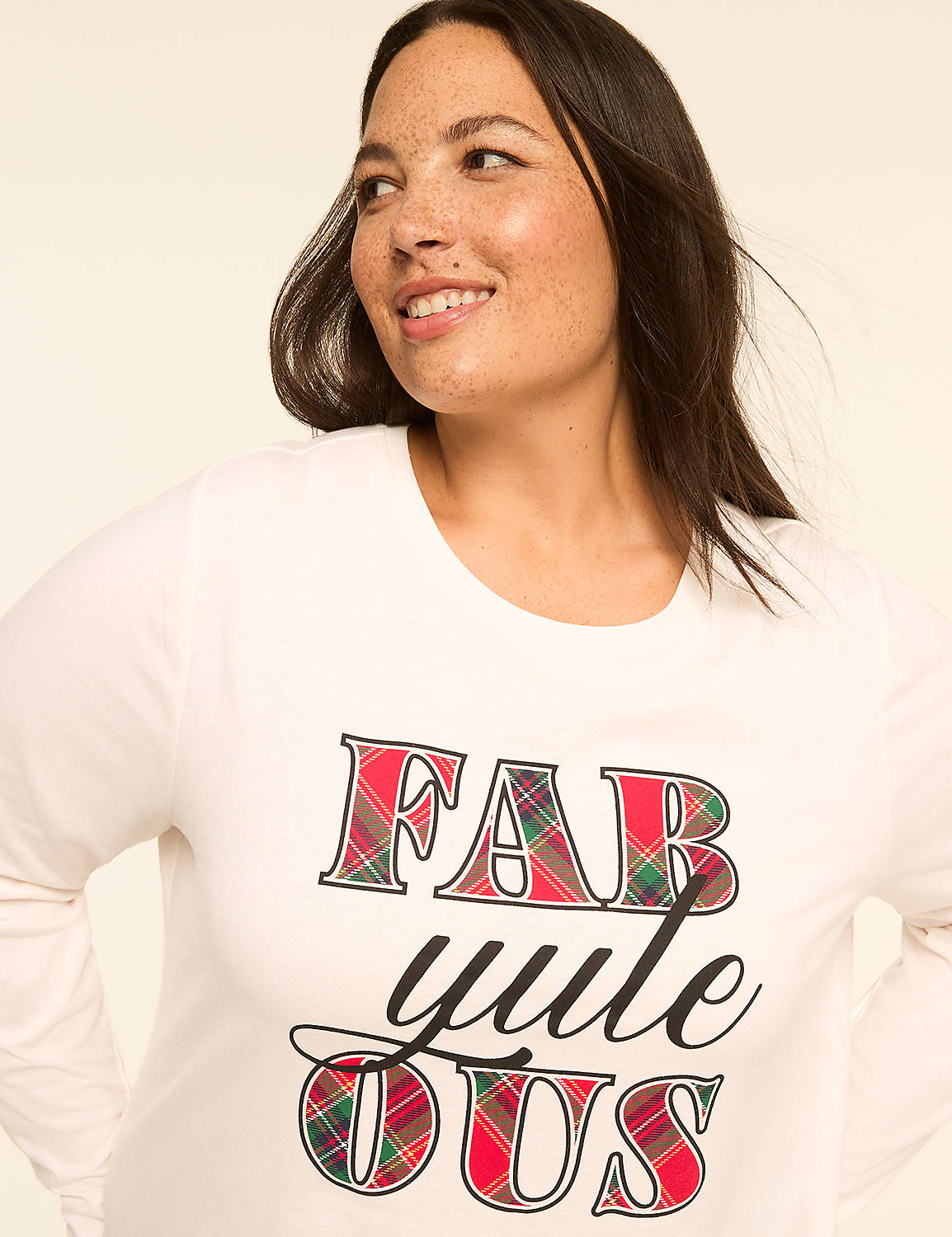 A smiling woman in a white long-sleeved shirt with "FAB yule OUS" printed on it is shown against a plain, light background. Product Image 3