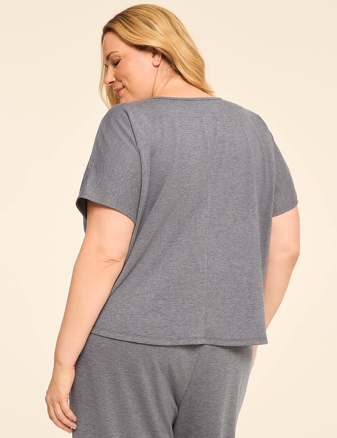 A woman in a grey top and pants stands against a plain cream background. Product Image 2