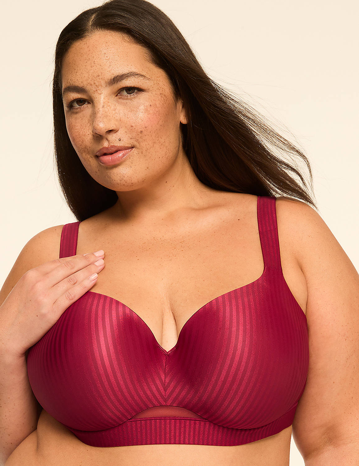 A woman with freckles in a burgundy striped bra poses against a plain, light-colored background. Product Image 1