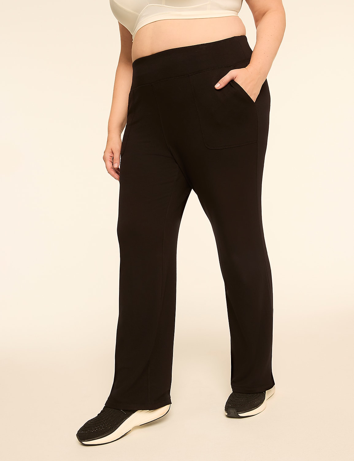 A person in black pants and sneakers stands against a plain, light-colored background. Product Image 1