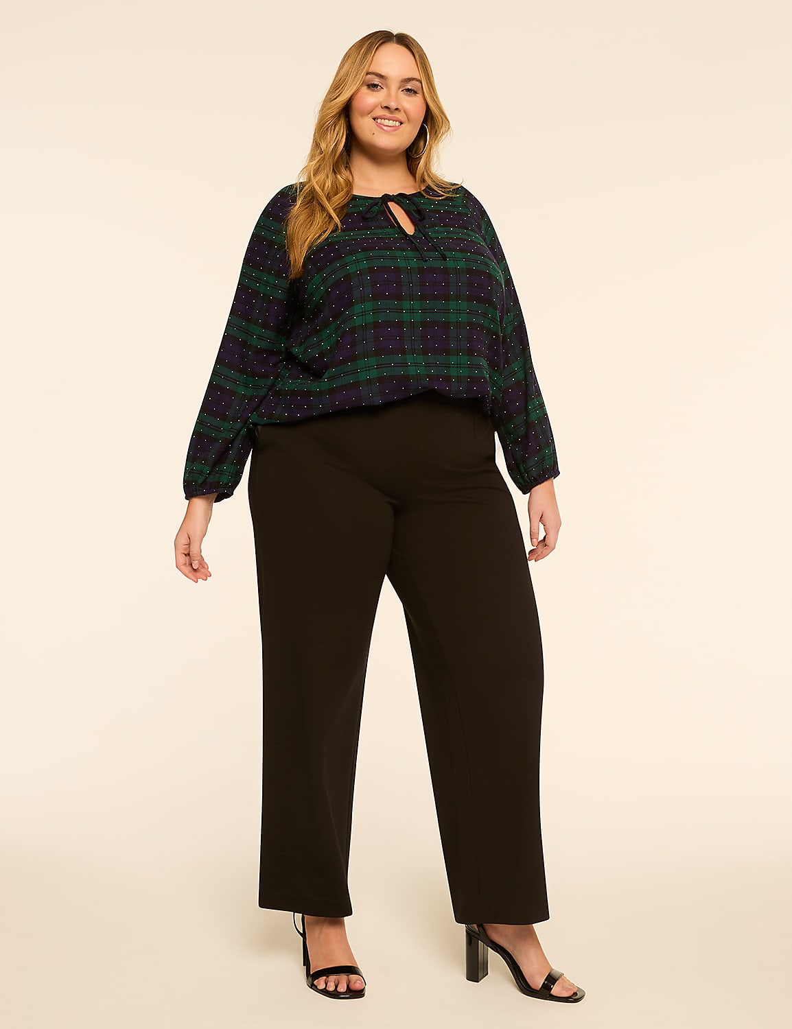 A woman in a plaid top and black pants stands against a plain, light-colored background. Product Image 3