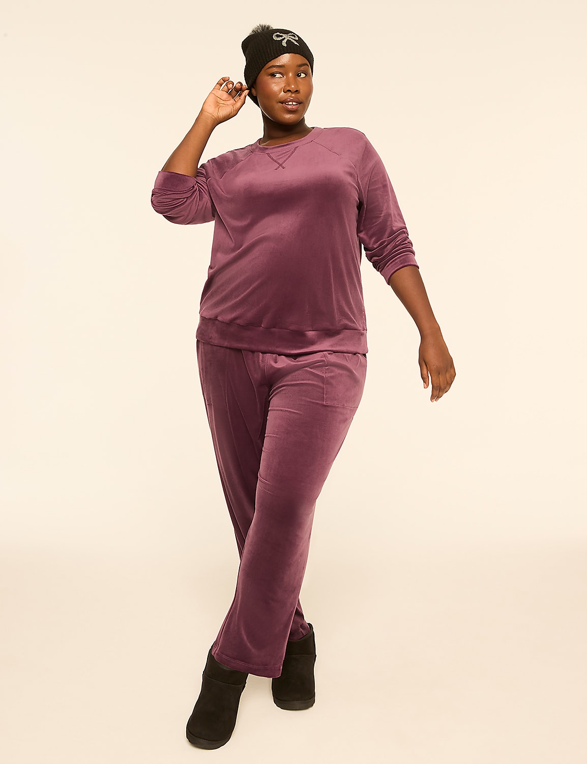 A woman in a purple velvet tracksuit and beanie poses against a plain, light-colored background. Product Image 3