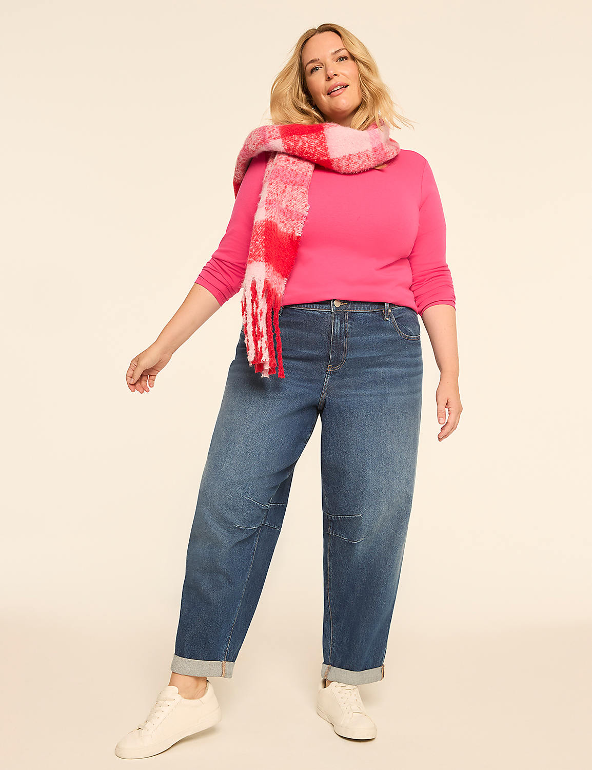 A woman in a pink sweater, blue jeans, and a colorful scarf stands against a plain, light-colored background. Product Image 3