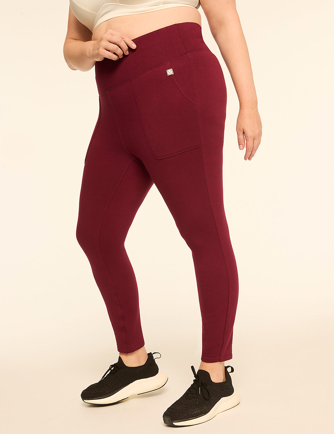 A person in maroon leggings and black sneakers stands against a plain, light-colored background. Product Image 1