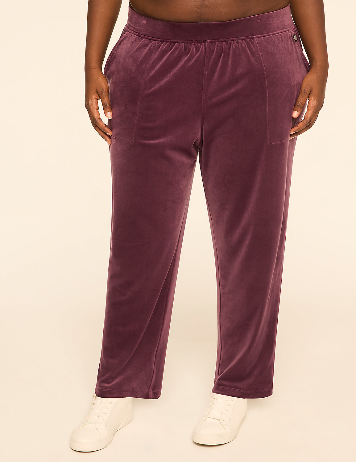 A person wearing plum-colored velour pants and white sneakers stands against a plain, light-colored background. Product Image 1