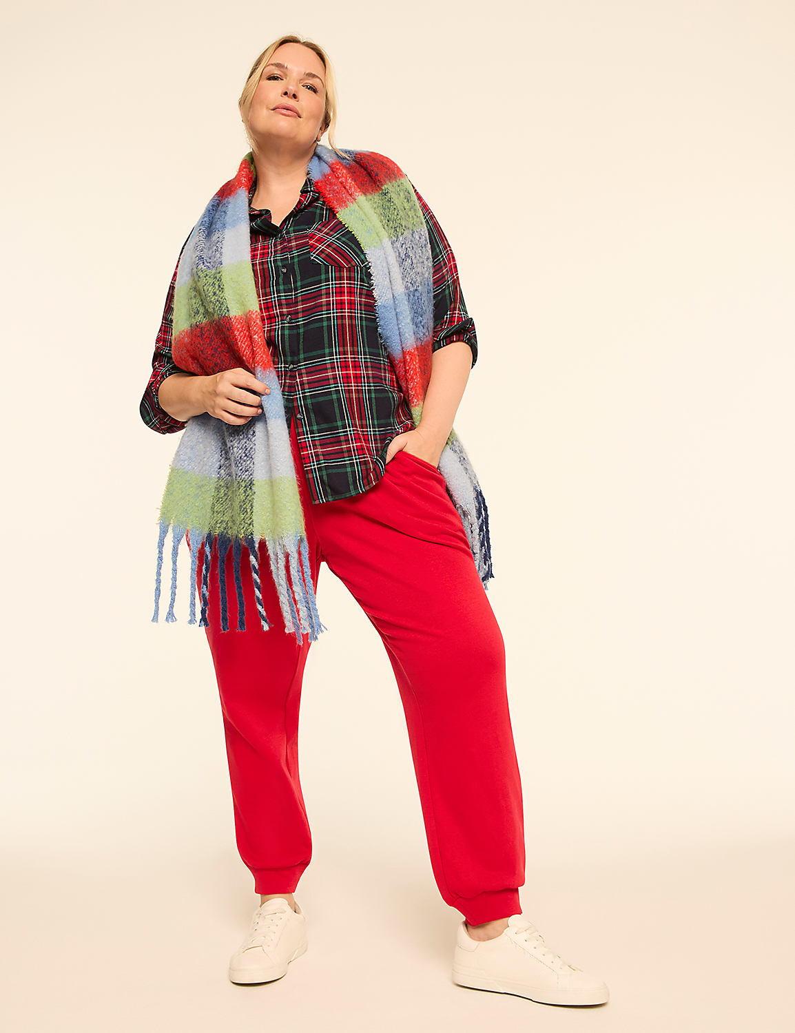 A woman in a plaid shirt, red sweatpants, and a colorful scarf stands against a plain, light-colored background. Product Image 4