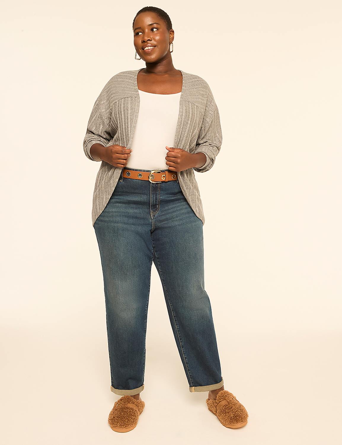 A woman in a white top, gray cardigan, and blue jeans stands against a plain, light-colored background, wearing fuzzy slippers. Product Image 3