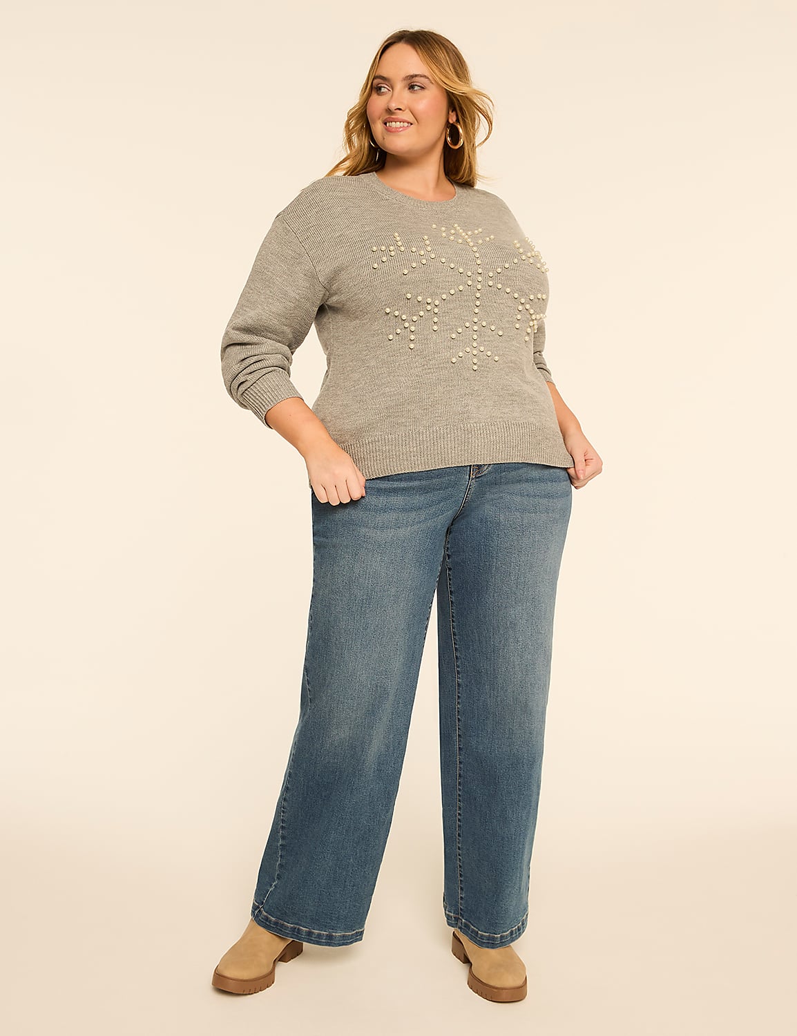 A woman in a pearl-embellished gray sweater and wide-leg jeans stands against a plain, light-colored background. Product Image 3
