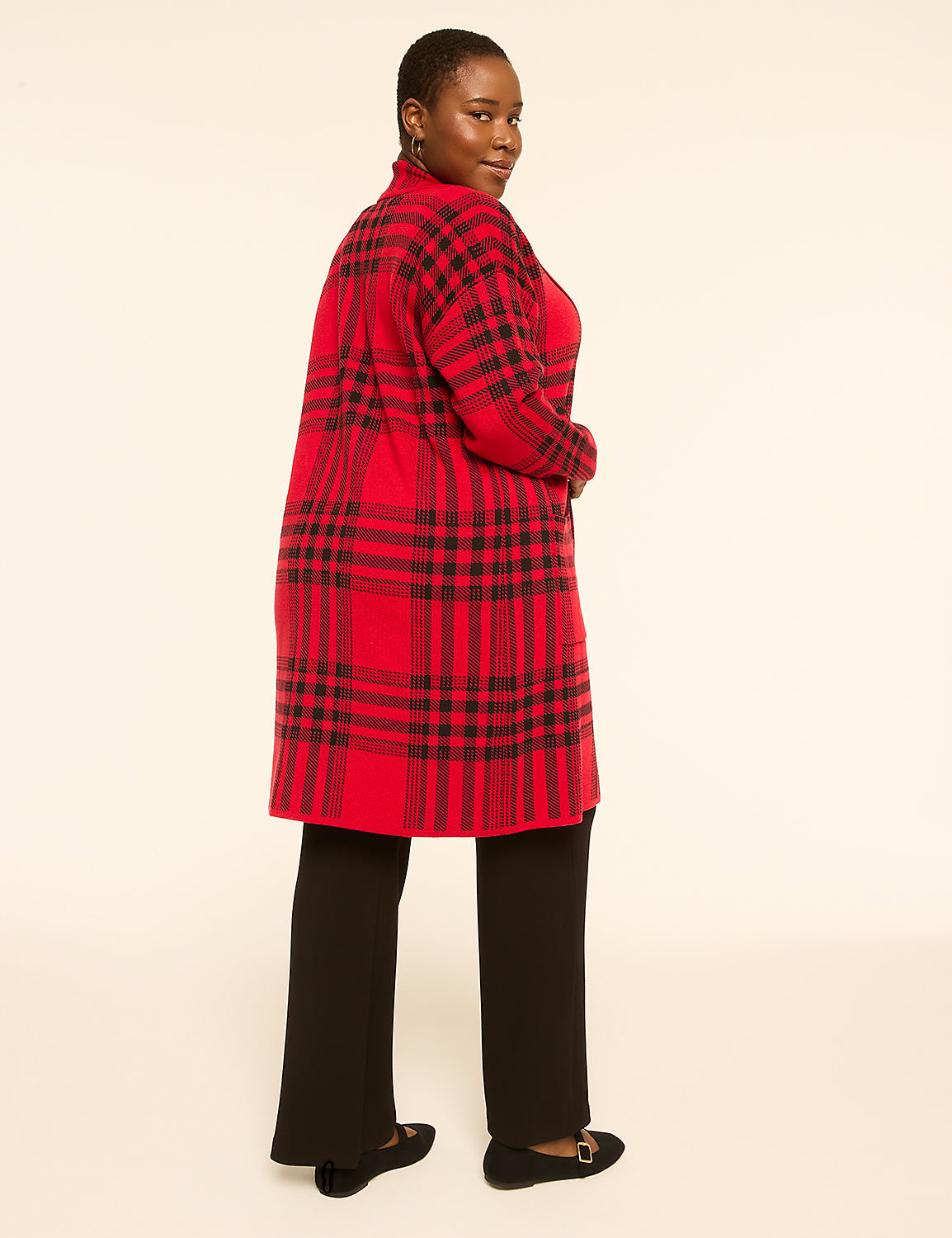 A woman in a red plaid cardigan and black pants stands against a plain, light-colored background. Product Image 2
