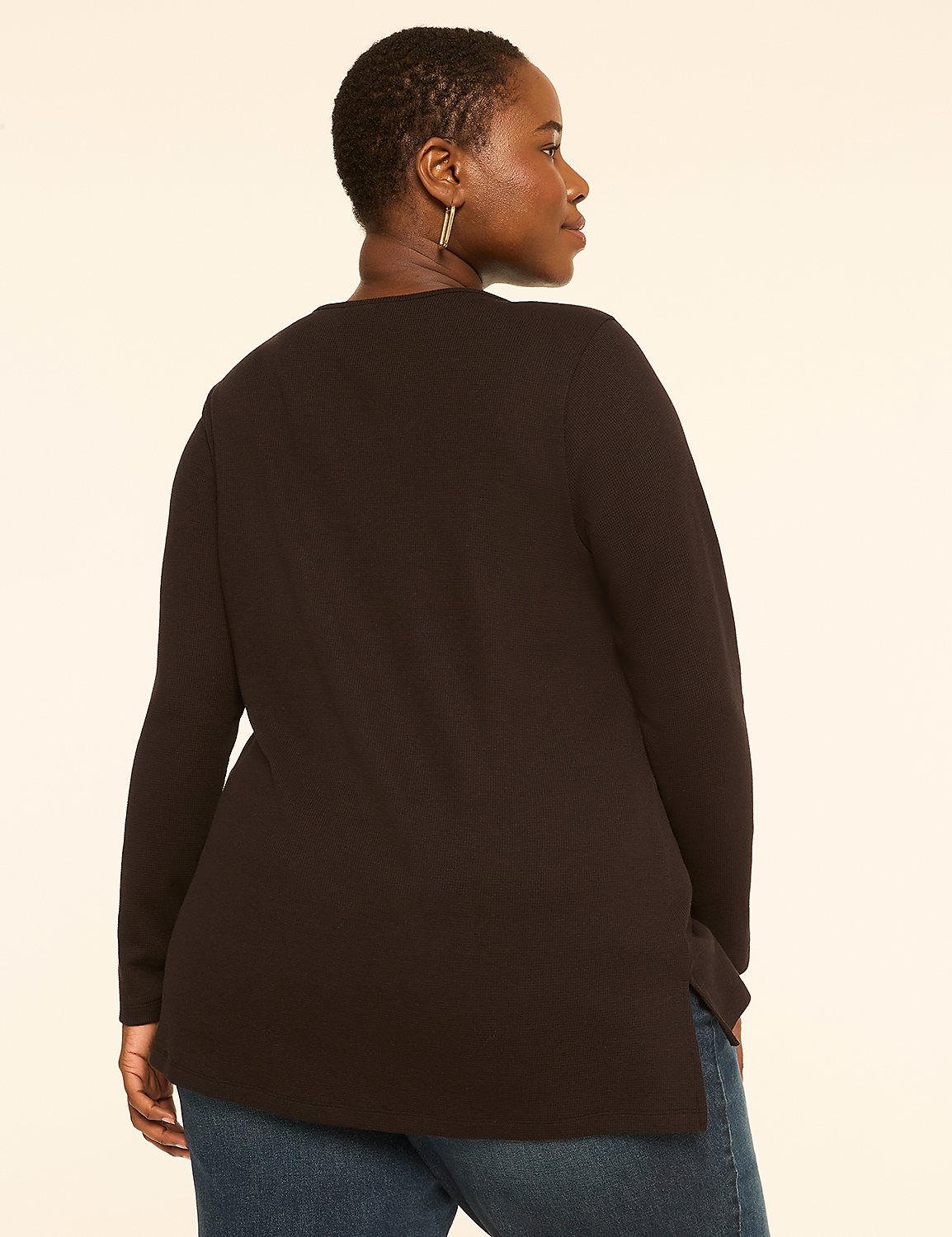 A woman in a black top and blue jeans stands against a plain, light-colored background. Product Image 2