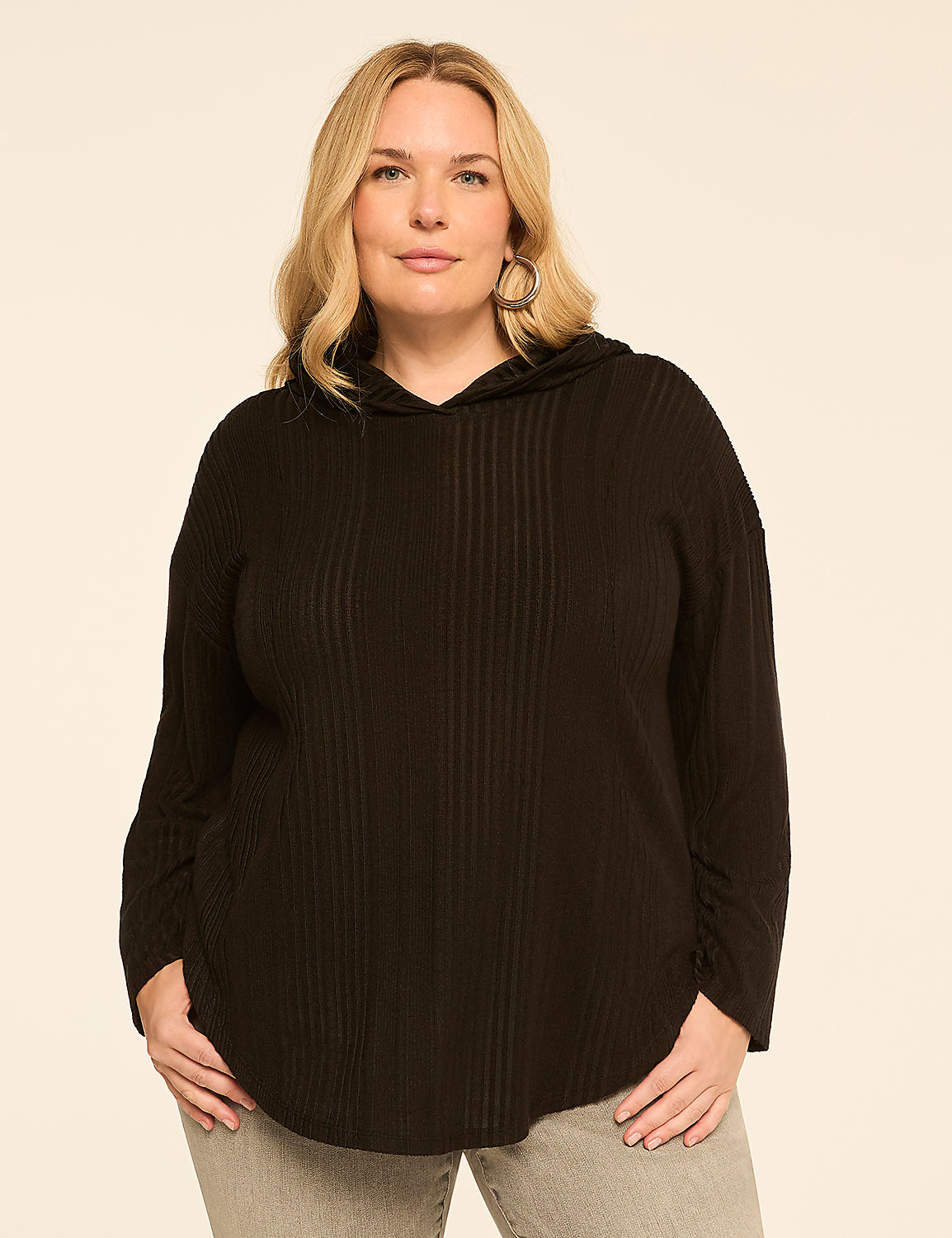 A woman in a black ribbed hoodie stands against a plain, light-colored background. Product Image 1