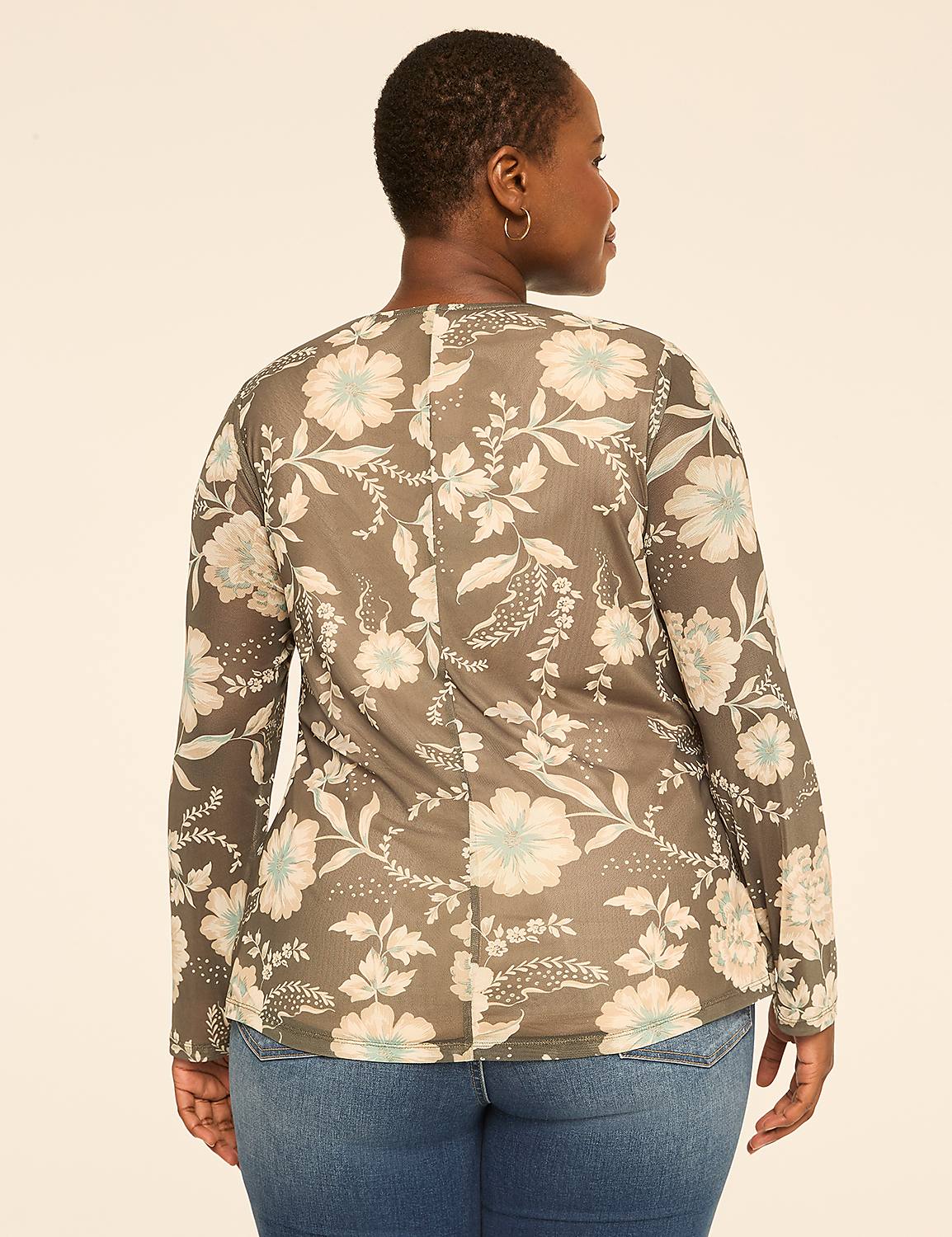A woman in a floral top and jeans stands against a plain, light-colored background. Product Image 2
