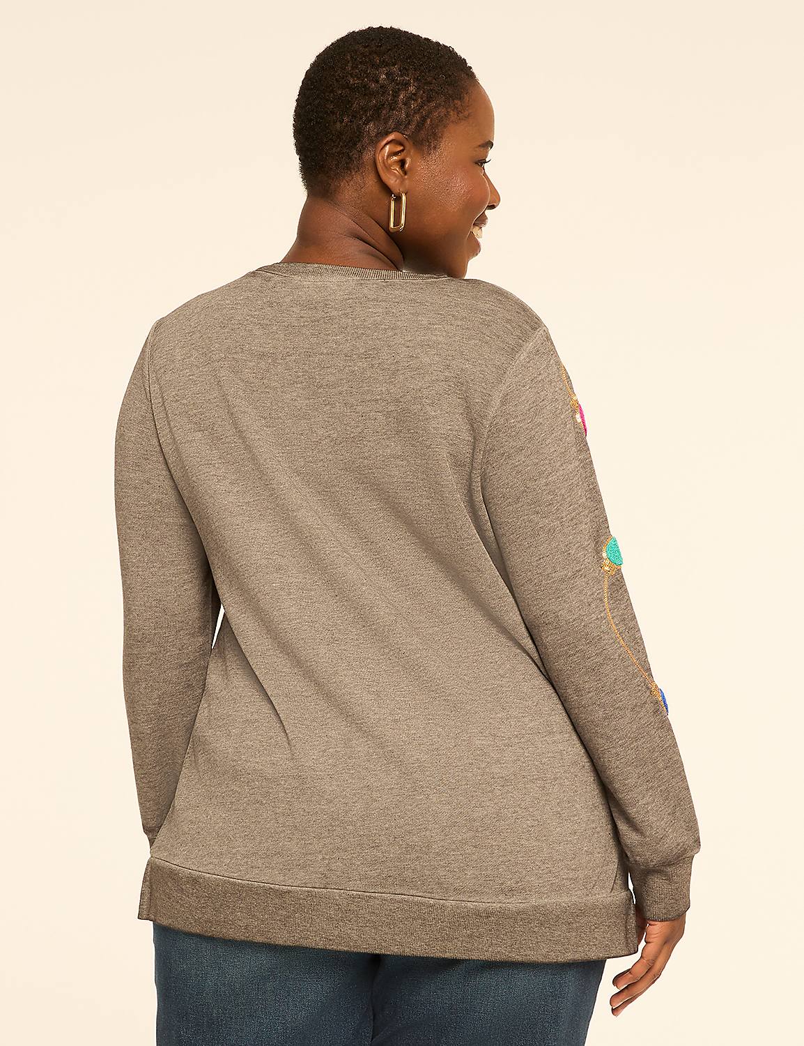 A woman in a gray sweatshirt with colorful string lights on the sleeve stands against a plain, light-colored background. Product Image 2