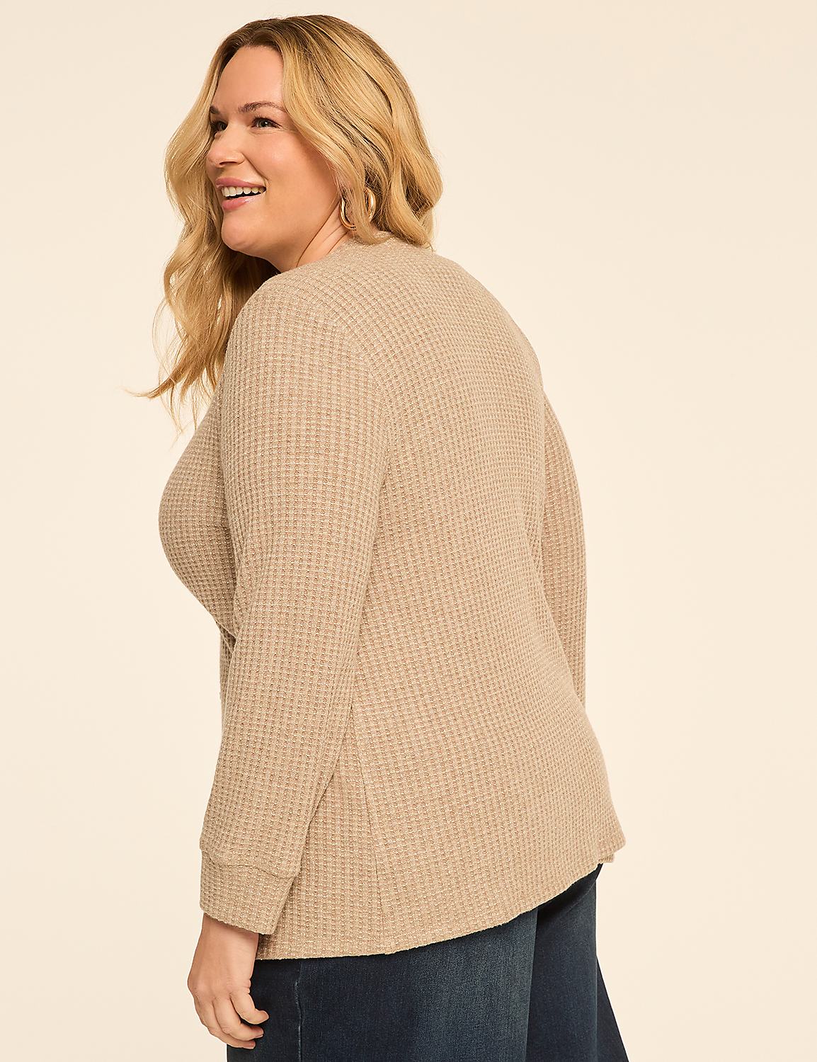 A smiling woman in a beige waffle-knit top and dark jeans is shown against a plain, light-colored background. Product Image 2