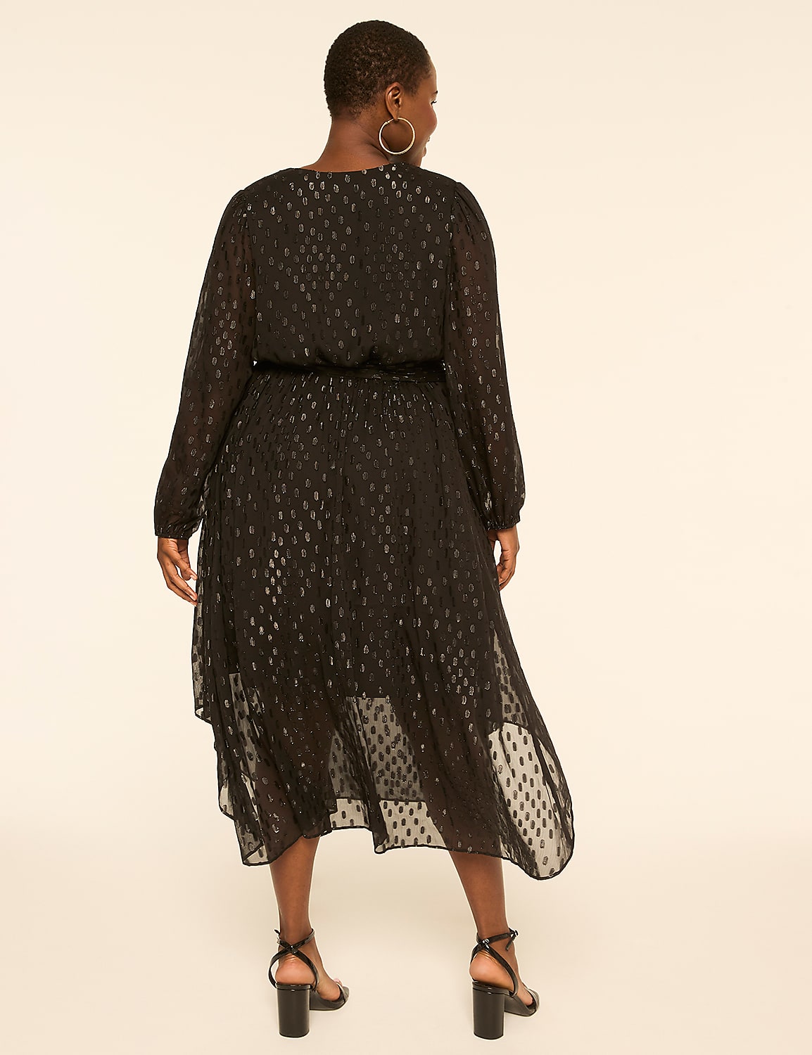 A woman in a black, shimmering dress stands against a plain, light-colored background. Product Image 2