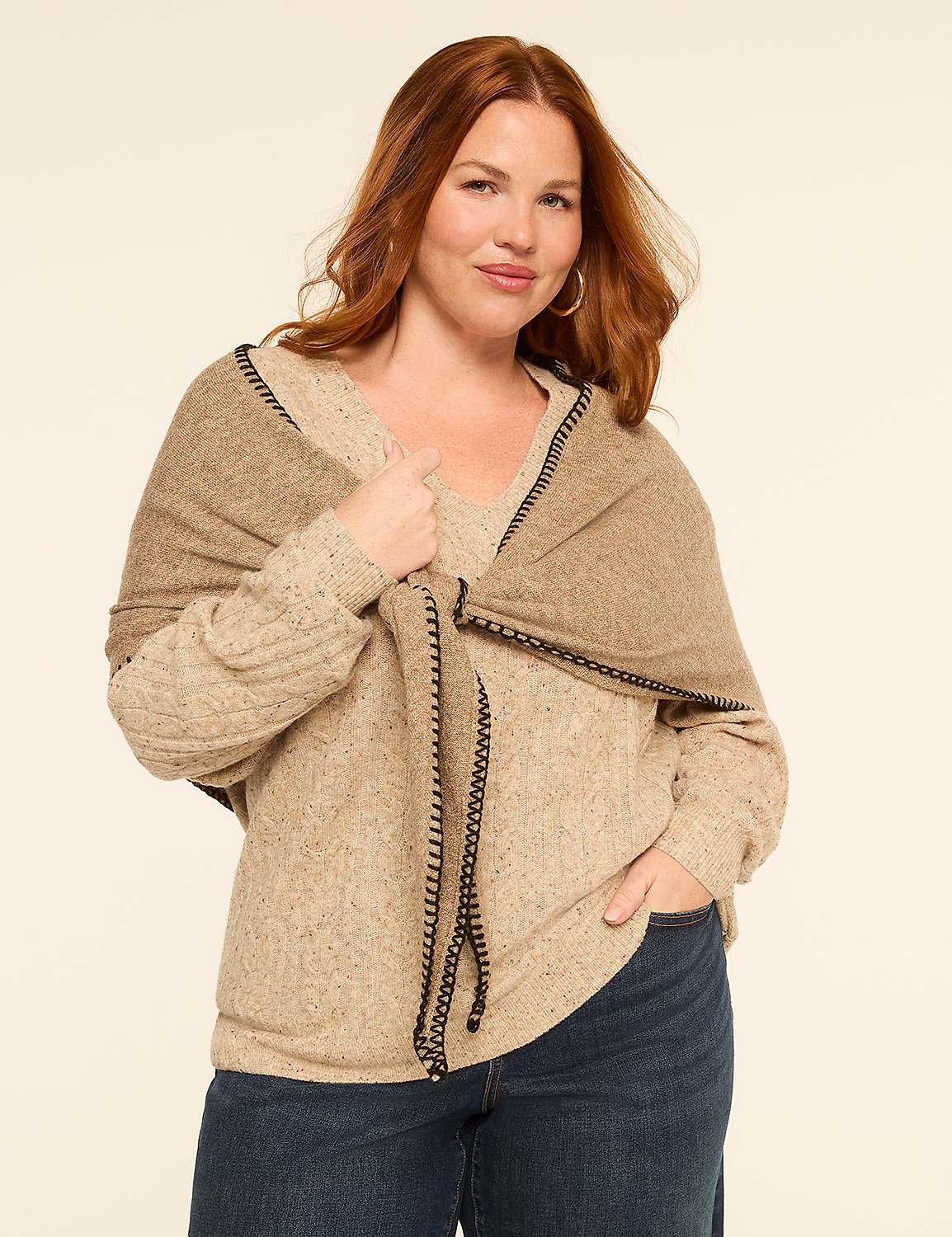 A woman with auburn hair poses in a beige sweater and jeans, with a tan shawl draped over her shoulders, against a plain, light-colored background. Product Image 1