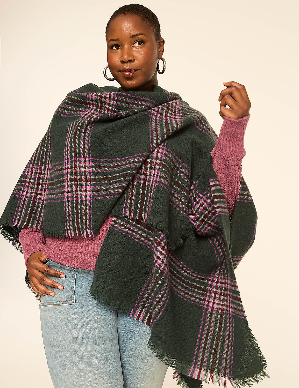 A woman in a pink sweater and jeans wears a green plaid shawl in front of a plain background. Product Image 4