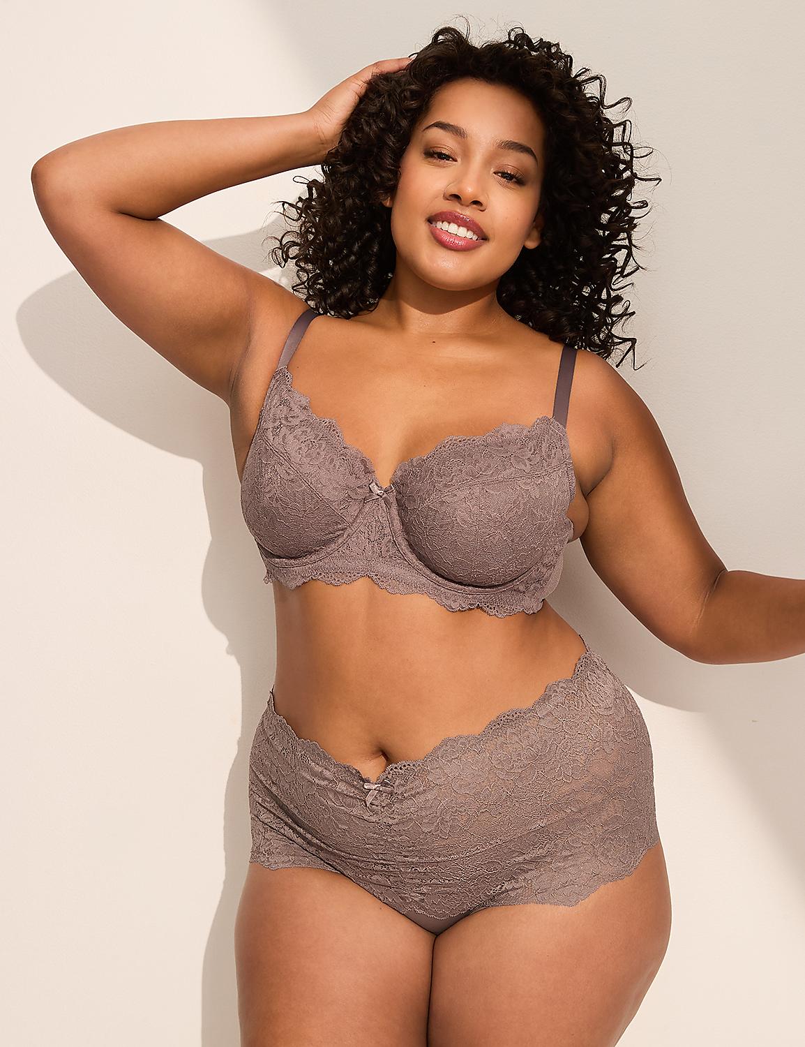 A woman in a lace bra and shorts poses against a plain, light-colored wall with soft shadows. Product Image 4