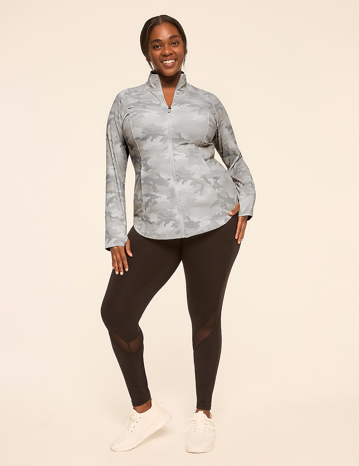 A smiling woman in a patterned jacket and black leggings stands against a plain, light-colored background. Product Image 3