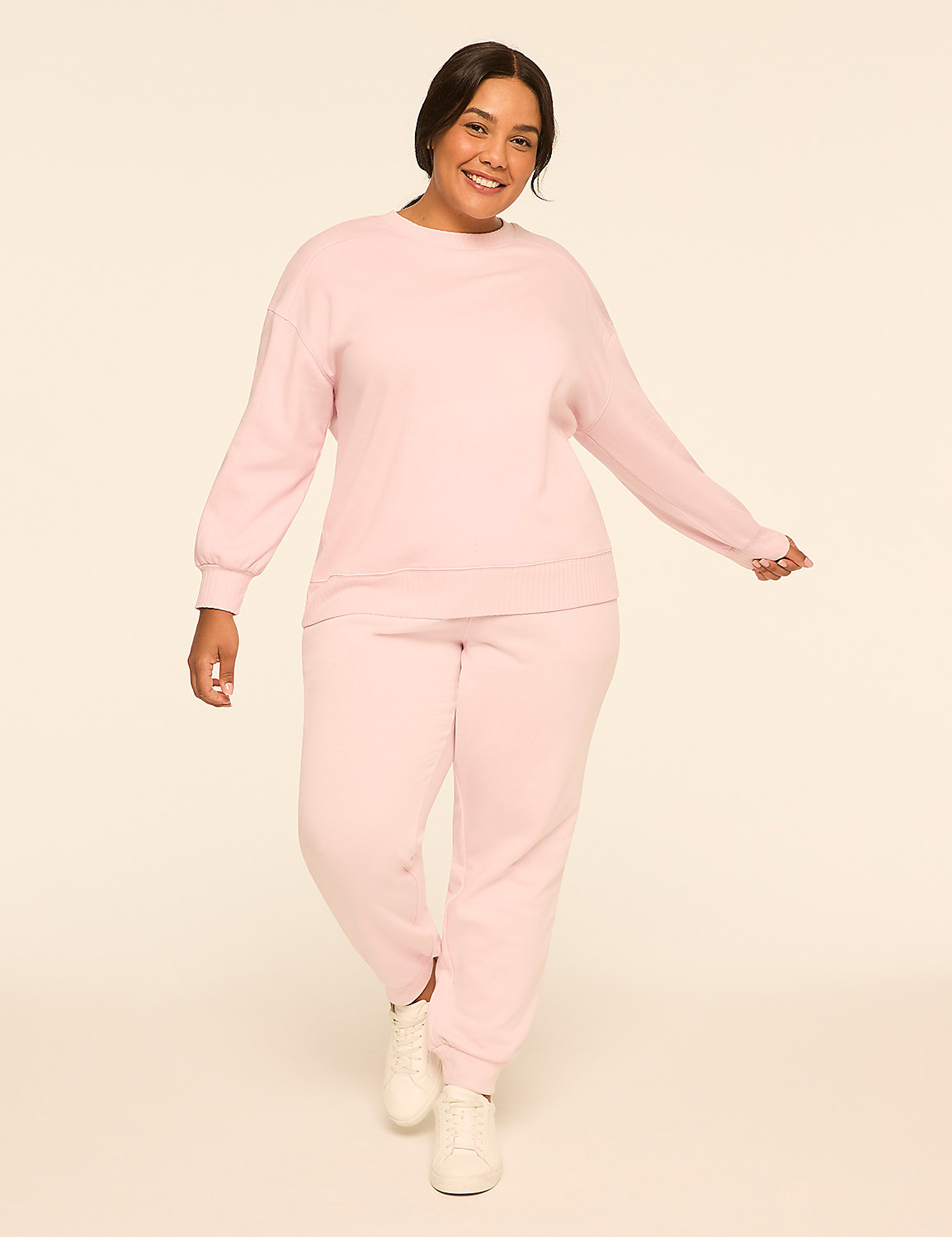 A smiling woman in a pink loungewear set stands against a plain, light-colored background. Product Image 3