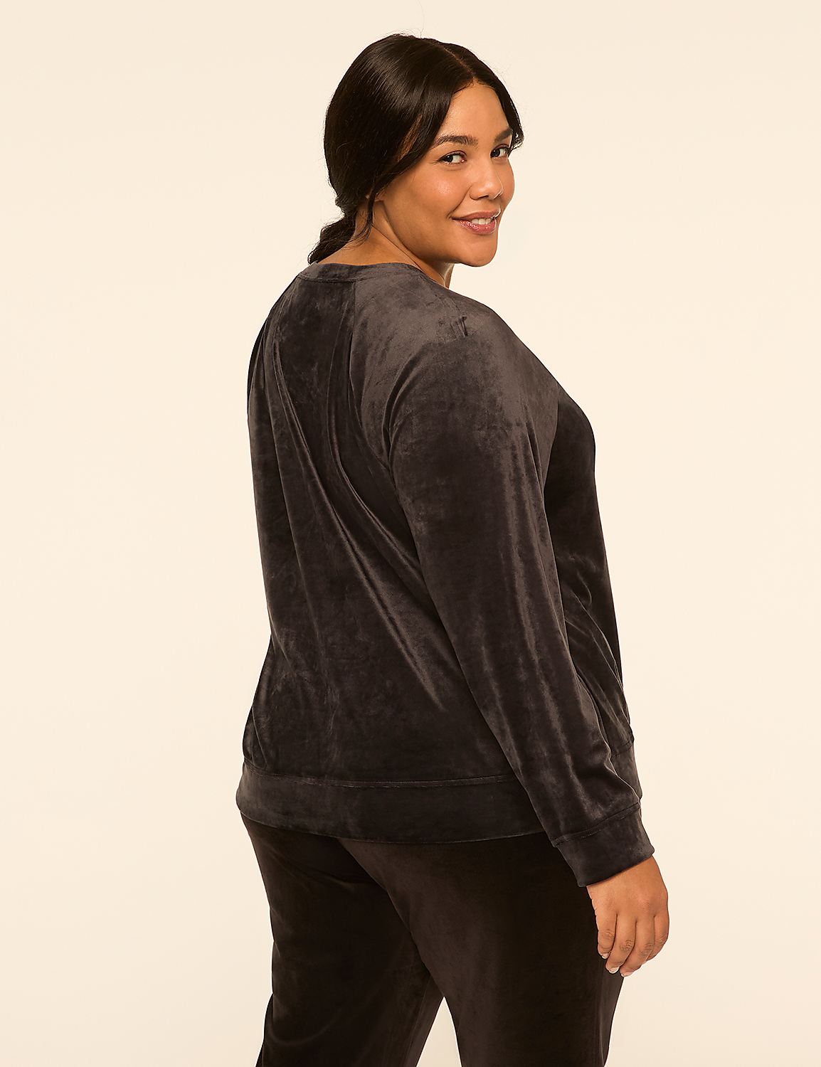A woman in a dark grey velour tracksuit poses against a plain, light-colored background. Product Image 2