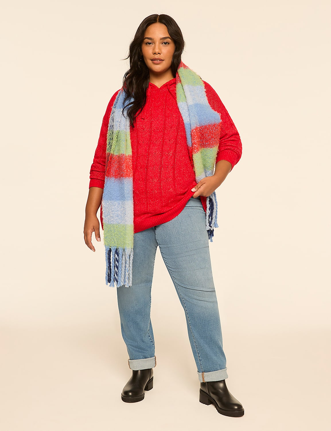 A woman in a red sweater, jeans, and a colorful scarf stands against a plain, light-colored background. Product Image 3