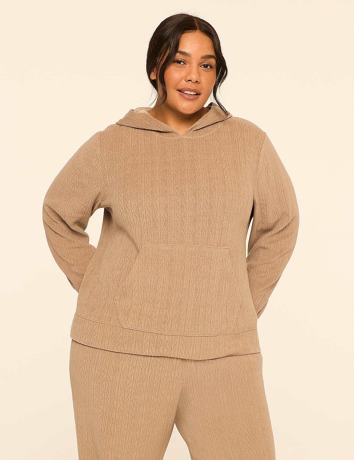 A woman in a tan hoodie and matching pants stands against a plain, light tan background. Product Image 1