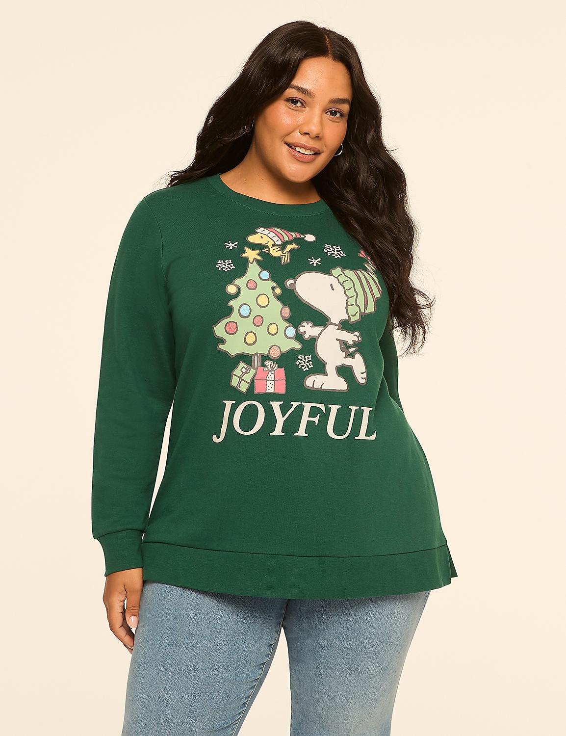 A woman in a green Christmas sweatshirt with Snoopy and Woodstock stands against a plain, light-colored background. Product Image 1
