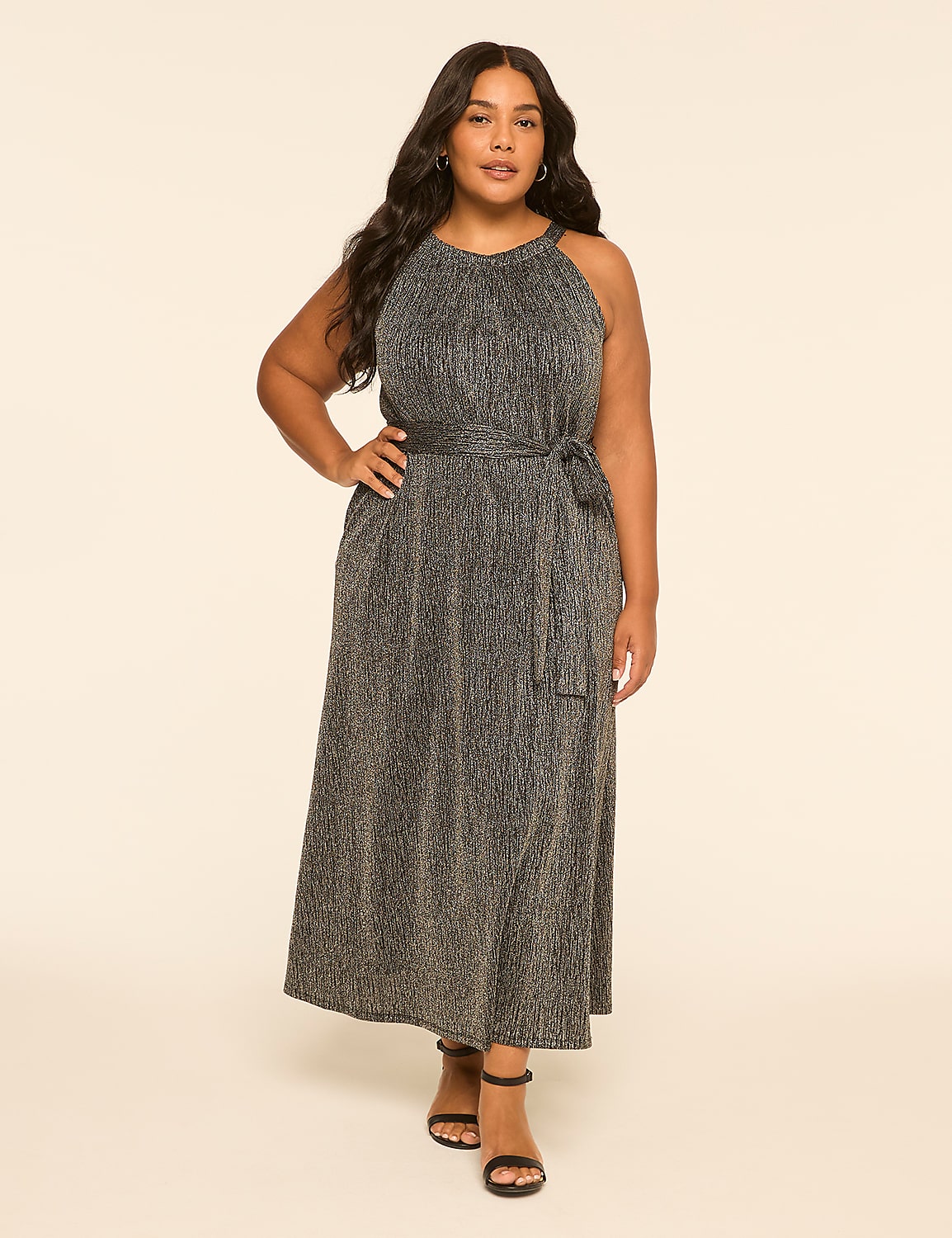 A woman in a sparkly silver dress stands against a plain, light-colored background. Product Image 1